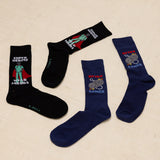 Two pairs of socks with superhero and gaming designs on a beige background thumbnail