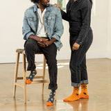 Two people wearing Halloween-themed socks in a casual setting. thumbnail