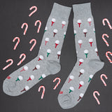 Gray socks with candy cane and golf ball patterns on a black background