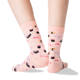 A pair of light pink crew socks with a sushi print, shown on a person's feet against a clean white background. thumbnail