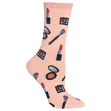 A single light pink crew sock with a repeating pattern of various makeup items, including lipstick, eyeshadow palettes, brushes, and mirrors, shown on a plain white background.