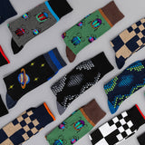 Collection of colorful mens socks with various patterns on a light gray background thumbnail