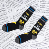Two socks with musical design and text on a sheet music background