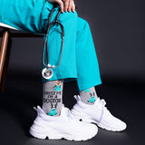 Person wearing teal scrubs with a stethoscope, white sneakers, and socks with 'Trust me, I'm a doctor' text and dog illustrations. thumbnail