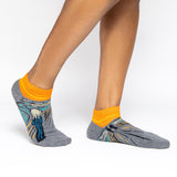 Gray and orange socks with a design inspired by 'The Scream' by Edvard Munch. thumbnail