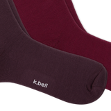Two pairs of crew socks from k.bell, fanned out on a white background, with three tiers of ruffled colors from dark plum to burgundy, maroon, and dusty pink. thumbnail
