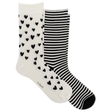 Two pairs of crew socks on a plain white background: one pair is white with small black heart patterns, and the other pair has black and white horizontal stripes. The brand name 'k bell' is printed on the toe area of the heart-patterned sock.