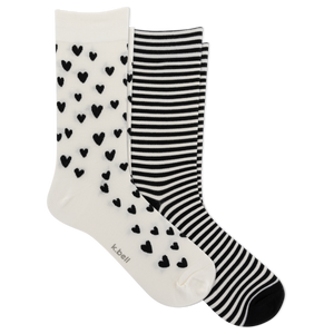 Two pairs of crew socks on a plain white background: one pair is white with small black heart patterns, and the other pair has black and white horizontal stripes. The brand name 'k bell' is printed on the toe area of the heart-patterned sock.
