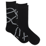 Two black crew socks with a white dotted pearl pattern, displayed on a clean white background. The brand name 'k-bell' is printed in white near the toe of the front sock. thumbnail