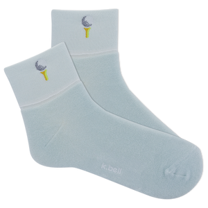 Light blue socks with embroidered designs on a white background