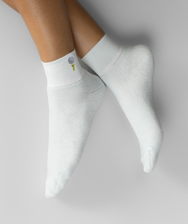 White socks with a small logo on a light gray background
