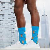 Person wearing blue socks with hot dog design in front of a city skyline