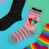 Colorful socks with rainbow patterns and 'PRIDE' text on a multicolored background