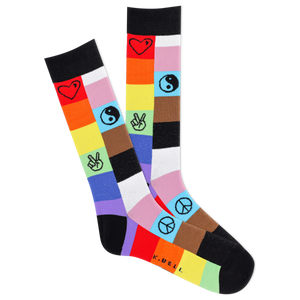 A pair of men's crew socks with a multicolored patch design featuring symbols such as hearts and peace signs.
