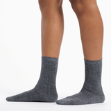Gray socks worn by a person on a white background