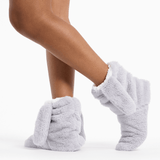 Gray fuzzy socks worn by a person on a white background thumbnail
