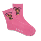 A pair of pink active crew socks with 'Women Unite' text and a fist graphic, and the brand name 'K.Bell' displayed at the bottom.