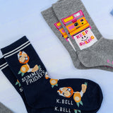 Two pairs of socks with designs and text on a light background